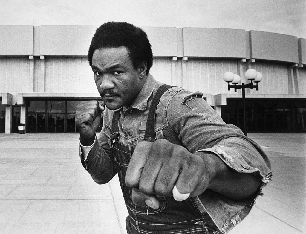 (Original Caption) 6/7/1976-Uniondale, New York: Heavyweight contender George Foreman strikes a fighting pose in front of Nassau Coliseum here where he meets Joe Frazier in a 12-round bout.